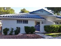 Charming home featuring a unique blue tiled roof, complemented by well-maintained landscaping and a secure gated entrance at 2028 Bavington Dr # A, Las Vegas, NV 89108