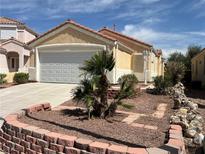 Charming single-story home with a well-maintained front yard and attached two-car garage at 2694 Hillgrass Rd, Las Vegas, NV 89123