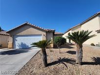 Charming single-story home featuring a two-car garage and desert landscaping at 2711 Morning Break Ct, Las Vegas, NV 89142