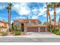 Beautiful two-story home boasts a three-car garage and manicured landscaping with swaying palm trees against a vibrant sky at 2741 Chokecherry Ave, Henderson, NV 89074