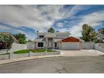 Charming two-story home featuring stone accents, manicured front yard, and a two-car garage in a cul-de-sac at 3143 El Chico Ct, Las Vegas, NV 89120