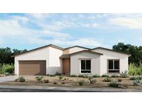 Charming single-story home featuring stucco and brick details, a two-car garage and desert landscaping at 454 Carter House Way, Las Vegas, NV 89113
