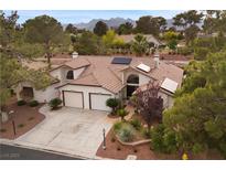 Inviting single-story home with a two-car garage, desert landscaping, and roof-mounted solar panels at 4909 Ocean Shores Way, Las Vegas, NV 89130