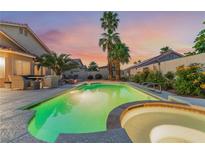 Backyard pool and spa with lush landscaping and a serene setting for relaxation and entertaining at 5350 Sharon Marie Ct, Las Vegas, NV 89118