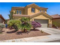 Charming two-story home featuring a well-manicured lawn, desert landscaping, and a two-car garage at 6440 Bristlebird St, North Las Vegas, NV 89084