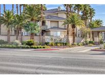 Beautiful condo exterior with mature landscaping, palm trees and signage at the entry to the community at 7155 S Durango Dr # 309, Las Vegas, NV 89113