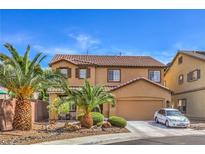 Charming two-story home with a well-maintained yard and mature palm trees at 75 Archer Glen Ave, Henderson, NV 89002
