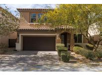 Charming two-story home featuring a two-car garage and drought-resistant landscaping at 7630 Canyon Diablo Rd, Las Vegas, NV 89179