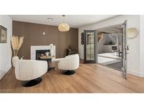 Inviting living room features modern fireplace and an open patio entrance at 7825 Desert Bell Ave, Las Vegas, NV 89128
