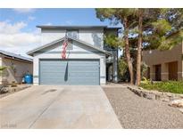 Charming two-story home featuring a well-maintained front yard and attached two-car garage at 823 Schooner Dr, Henderson, NV 89015