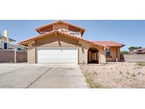 Charming two-story home featuring a red tile roof and an attached two-car garage in a sunny neighborhood at 864 E Eldorado Ln, Las Vegas, NV 89123