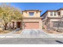 Inviting two-story home with stone accents, attached garage, and manicured front yard at 10212 Cider Mill Rd, Las Vegas, NV 89135