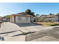 Charming single-story home featuring a spacious driveway and well-maintained front yard under a clear blue sky at 1105 Declaration Dr, Las Vegas, NV 89110