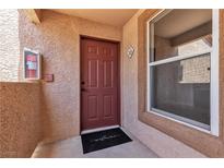Unit front door with welcome mat, fire extinguisher and window in a secure access building at 1150 N Buffalo Dr # 2025, Las Vegas, NV 89128