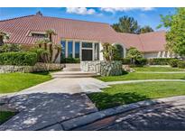 Stunning home featuring a red tile roof, well-manicured lawn, and attractive stone accents at 13 Dovetail Cir, Henderson, NV 89014