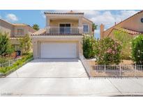 Charming two-story home with a well-manicured front yard, balcony and a two-car garage, enhancing its curb appeal at 2452 Silver Shadow Dr, Las Vegas, NV 89108