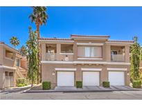 Well-maintained condo exterior with private garages, balconies, and lush landscaping in a desirable community at 251 S Green Valley Pkwy # 1421, Henderson, NV 89012