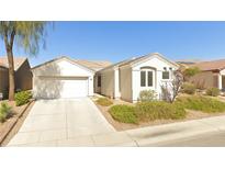 Charming single-story home featuring a two-car garage and well-maintained landscaping in a suburban neighborhood at 3228 Flinthead Dr, North Las Vegas, NV 89084