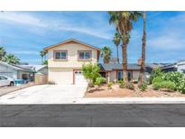Charming two-story home featuring desert landscaping, a two-car garage and a mix of palm trees at 3793 Casa Colorado Ave, Las Vegas, NV 89121