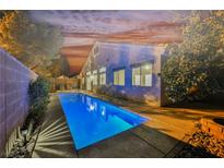 An inviting backyard featuring a private pool, lush landscaping, and a serene setting perfect for relaxation and entertainment at 4065 Genoa Dr, Las Vegas, NV 89141