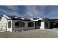 Charming home featuring an arched covered porch and solar panels on the roof at 5239 Treasure Ave, Las Vegas, NV 89122