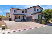 Charming two-story home featuring a brick driveway and meticulously maintained landscaping at 5425 Pride Mountain St, North Las Vegas, NV 89031