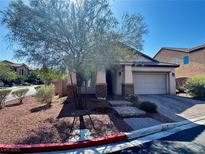 Charming single-story home with desert landscaping, stone accents, and a two-car garage at 7035 Thistle Ridge St, Las Vegas, NV 89166