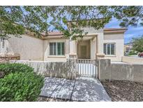 Charming single-story home featuring a gated front courtyard with stucco and brick accents at 7465 Widewing Dr, North Las Vegas, NV 89084