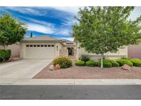 Charming single-story home featuring a well-manicured front yard, desert landscaping, and a two-car garage at 7606 Grove Acre Ct, Las Vegas, NV 89131