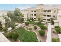 Spacious condo complex features a manicured courtyard with lush landscaping and walkways at 8777 Maule Ave # 3116, Las Vegas, NV 89148