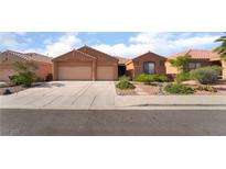 Charming single-story home with a three-car garage, desert landscaping, and neutral color palette at 940 Rifle Dr, Henderson, NV 89002