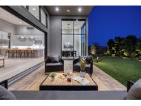 Inviting outdoor patio with comfortable seating and seamless transition to the modern kitchen at 10781 Agate Cliffs Ave, Las Vegas, NV 89135