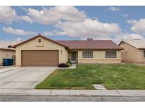 Charming single-story home featuring a red tile roof, a well-manicured lawn, and an attached two car garage at 1835 Banaba Ln, Las Vegas, NV 89156