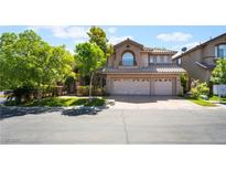 Charming two-story home featuring mature trees, a tile roof, and an attached two-car garage at 2008 Aspen Oak St, Las Vegas, NV 89134