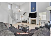 Inviting living room with high ceilings, fireplace, and comfortable seating arrangement at 217 Turkey Creek Way, Henderson, NV 89074