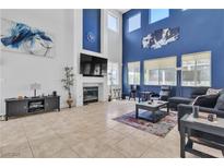 Open living room with high ceilings, fireplace, and lots of natural light at 217 Turkey Creek Way, Henderson, NV 89074