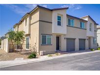 Modern townhome featuring a two-car garage and low-maintenance landscaping at 2773 Green Envy Ave # 245, North Las Vegas, NV 89086