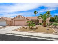 Charming single-story home with desert landscaping, mature palm trees and two-car garage at 3121 Fontana Colony Ct, North Las Vegas, NV 89031