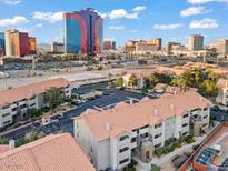 Expansive view of condos with orange tile roofs and a vibrant Las Vegas skyline in the background at 4200 S Valley View Blvd # 1007, Las Vegas, NV 89103