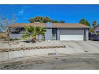 Charming single-story home featuring a two-car garage, xeriscaping, and mature palm tree at 4556 Kenilworth Ct, Las Vegas, NV 89147