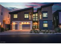 Striking modern home featuring a three car garage and contemporary architectural details at 5364 Succulent Rose Dr, Las Vegas, NV 89135