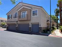 Charming townhome featuring a private balcony, three garages, and stone accents at 67 Dow Jones St # 2, Henderson, NV 89074