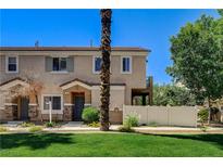 Charming two-story townhome with a well-manicured lawn and cozy front porch at 67 Dow Jones St # 2, Henderson, NV 89074