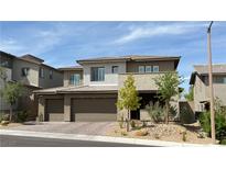 Modern two-story home with a three car garage, neutral color scheme, and low maintenance landscaping at 754 Agate Hills St, Las Vegas, NV 89138