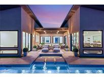 Inviting pool with lounge chairs and serene courtyard, creating a luxurious outdoor retreat at 826 Bolide St, Las Vegas, NV 89138