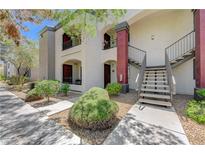 Attractive condo exterior showcasing lush landscaping, stairs to the second level, and stylish architectural details at 950 Seven Hills Dr # 1921, Henderson, NV 89052