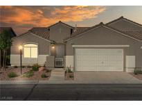 Charming single-story home with a two-car garage and landscaped front yard under a lovely sunset sky at 11082 Sospel Pl, Las Vegas, NV 89141