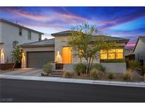 Charming single-story home with a well-manicured front yard and attached two-car garage, set against a beautiful twilight sky at 11672 Barga Ct, Las Vegas, NV 89138