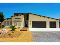 Beautiful single-story home featuring a modern design, three-car garage, and desert landscaping at 1801 S Manzanita Dr, Pahrump, NV 89048