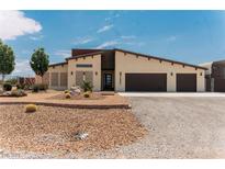 Charming single-story home features desert landscaping, a spacious driveway and a two-car garage at 1801 S Manzanita Dr, Pahrump, NV 89048